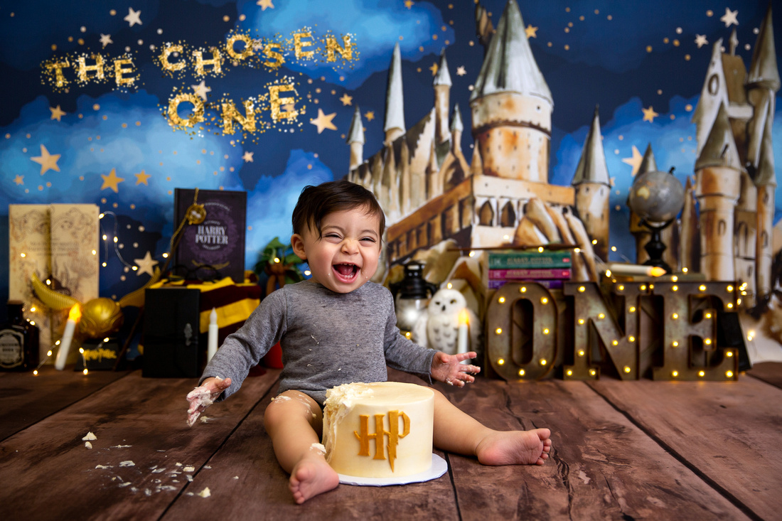 Baby smashing a cake during a photo shoot