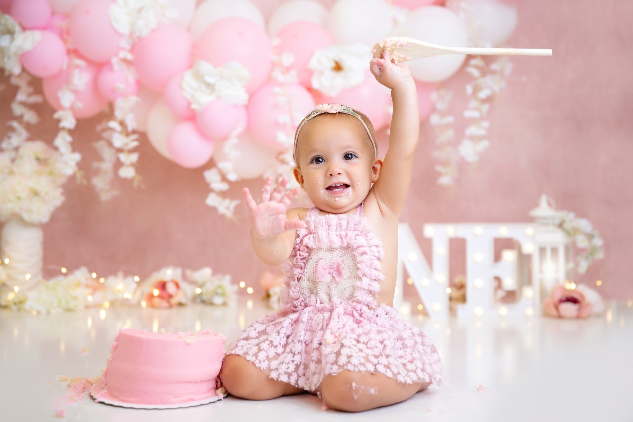 Baby smashing a cake during a photo shoot