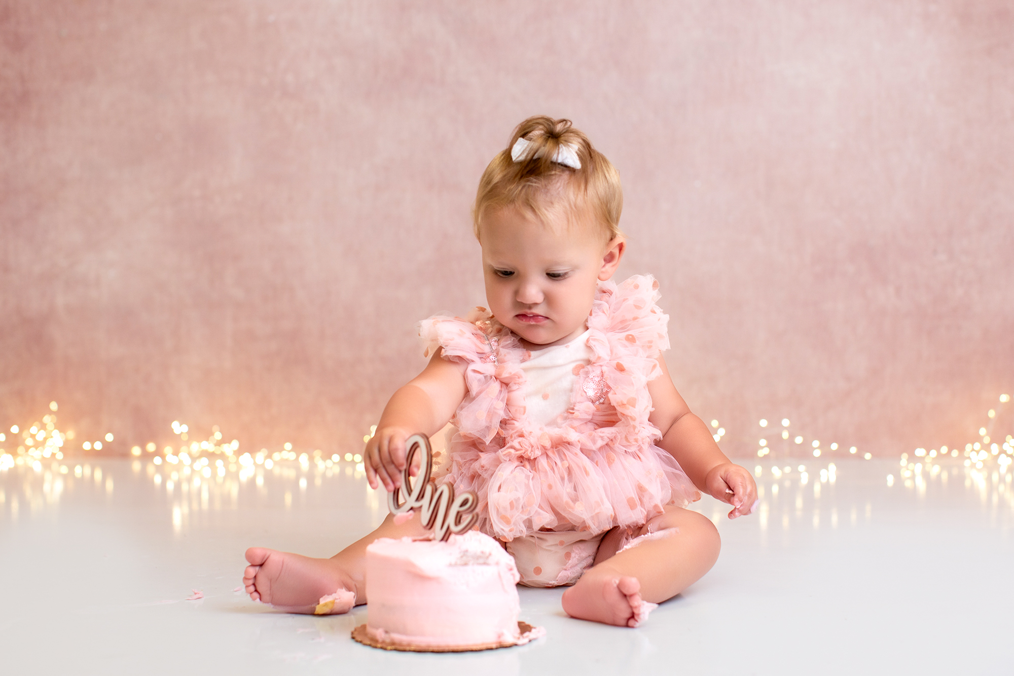 Baby smashing a cake during a photo shoot