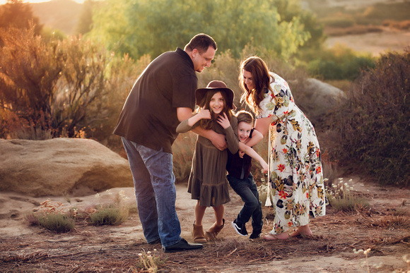 Family playing outside while the sun sets